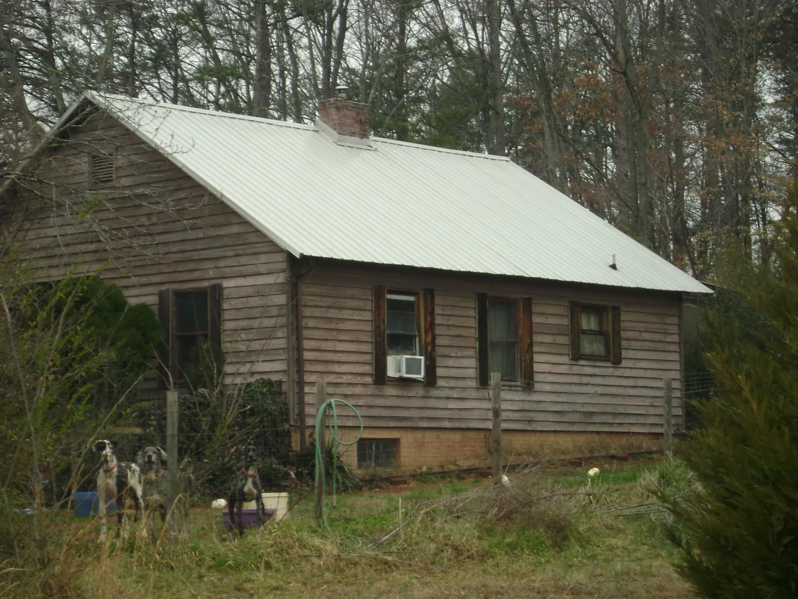 White metal roof on an old wood sided farmhouse, from a Metal Roof Installation job in Beccaria